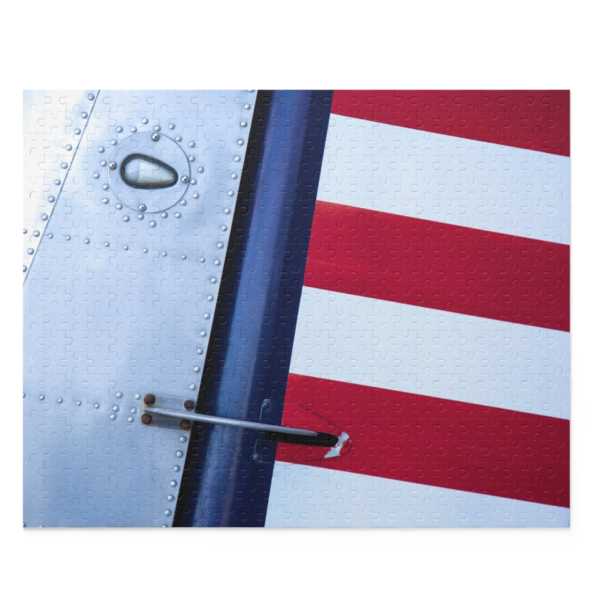 Close-up of an airplane's metal surface with a red, white, and blue pattern.
