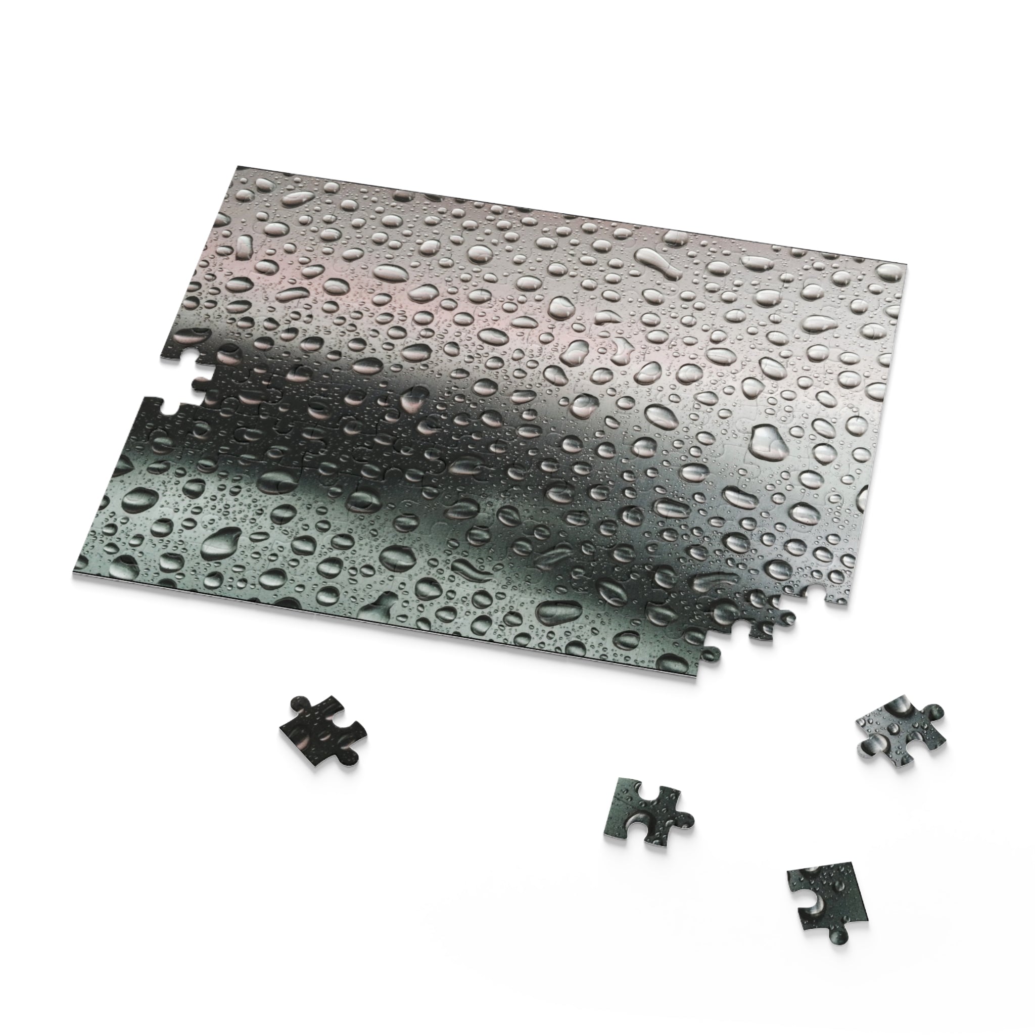 Metallic puzzle pieces with water droplets on a white background