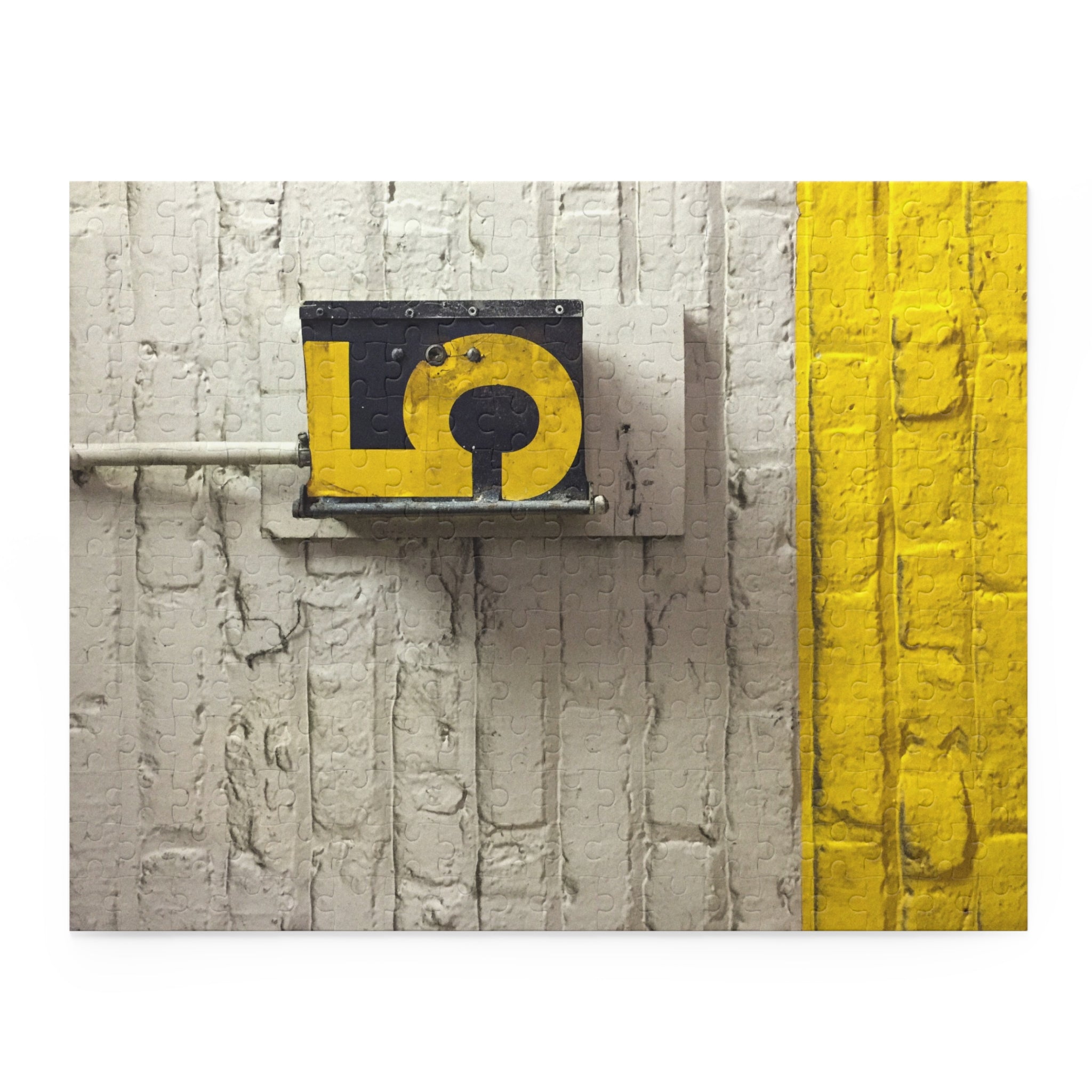Yellow question mark symbol on a metal plate attached to a textured wall with a yellow stripe.