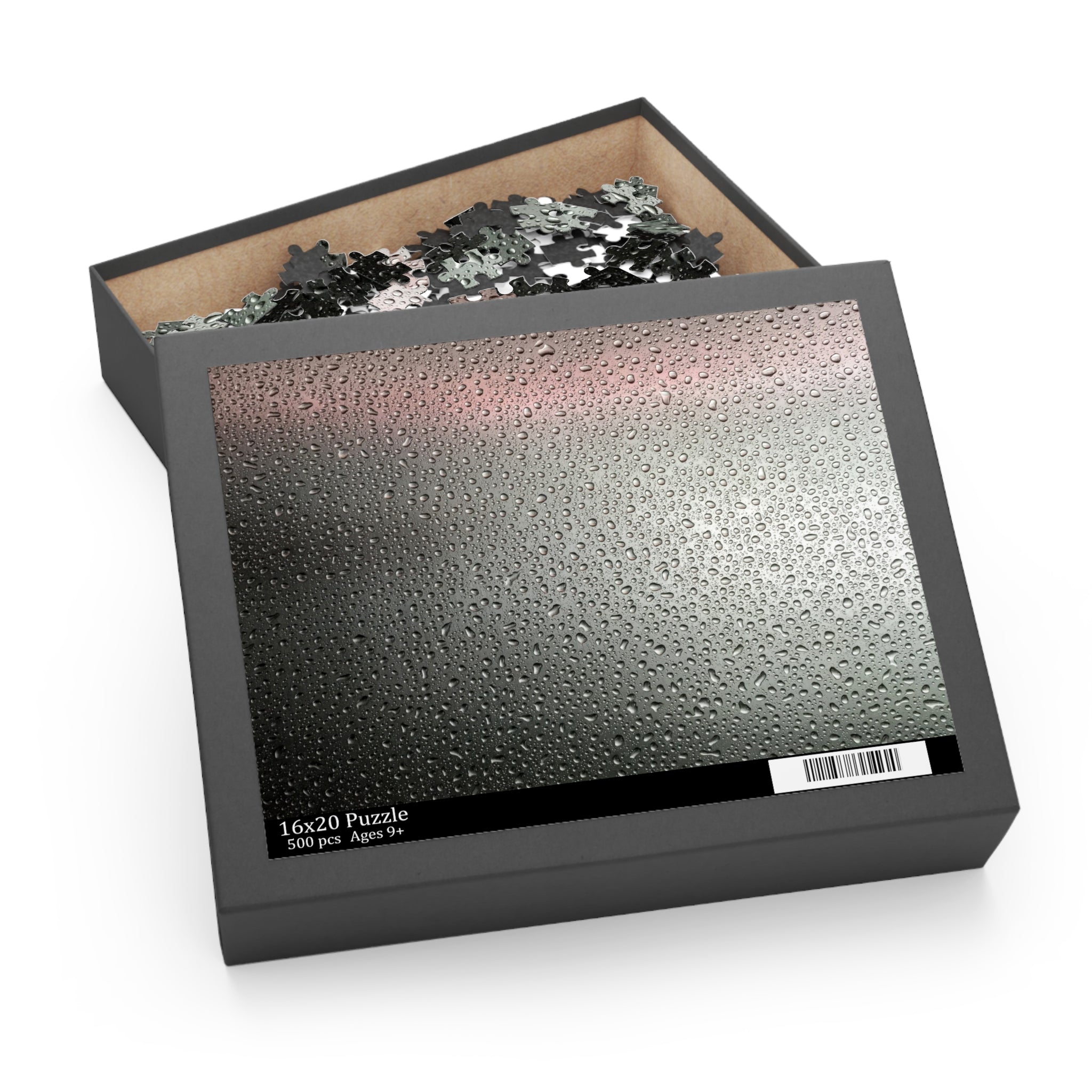 Jigsaw puzzle in a black box with a clear lid showing puzzle pieces.