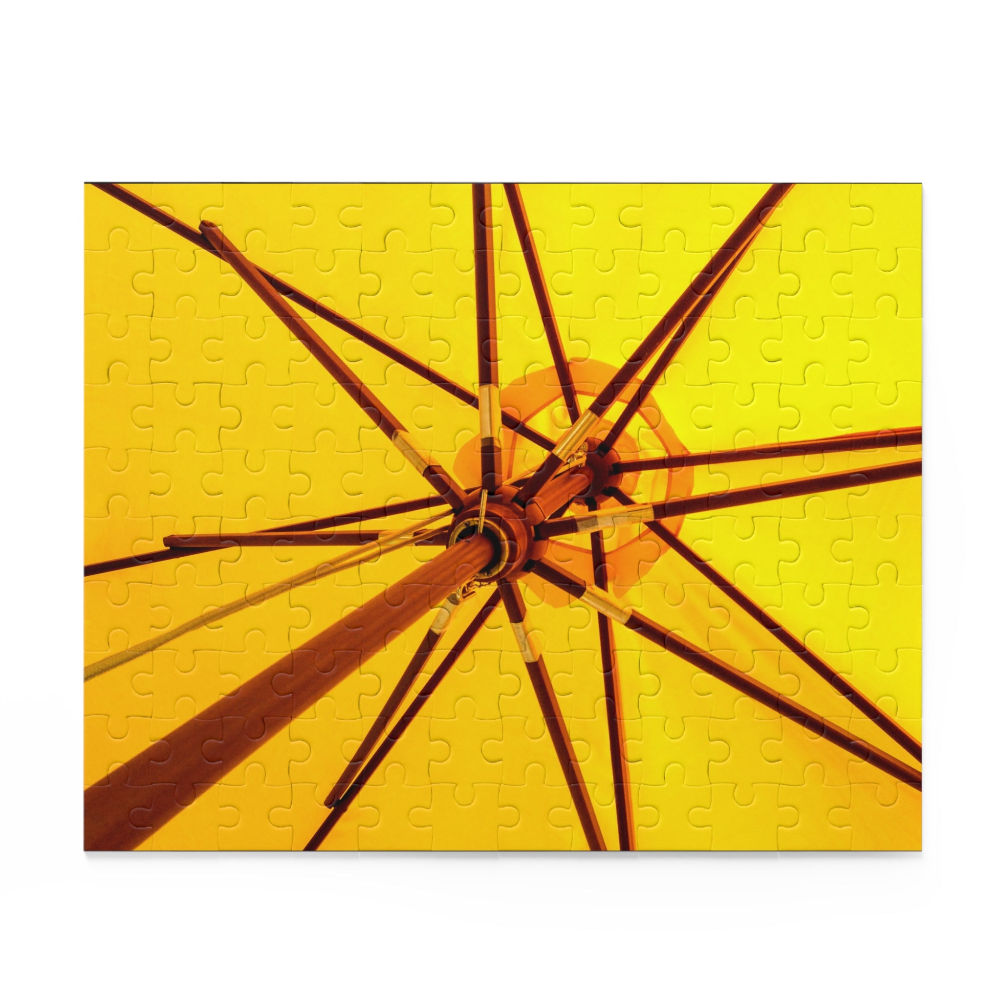 Jigsaw puzzle with a yellow and brown design of an umbrella on a white background