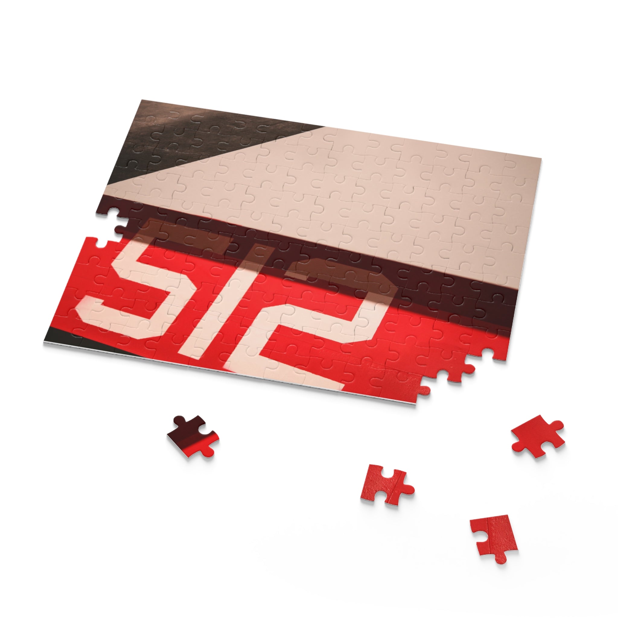 Jigsaw puzzle with red and beige pieces on a white background
