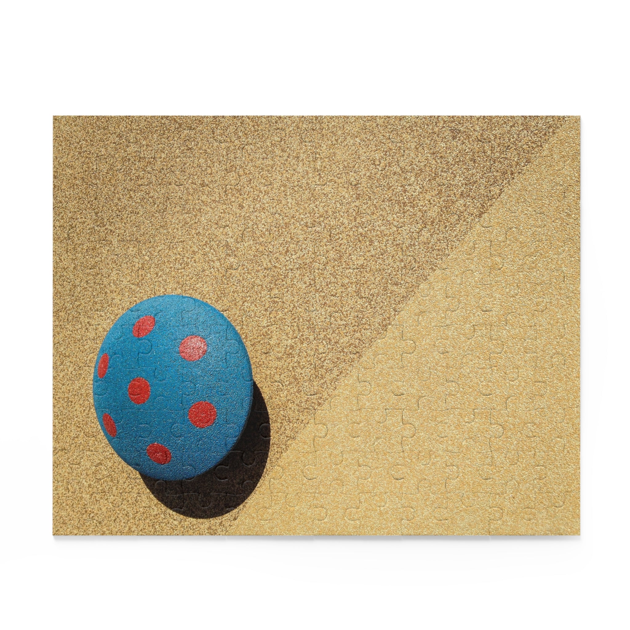 Blue stone with red spots on a textured beige surface
