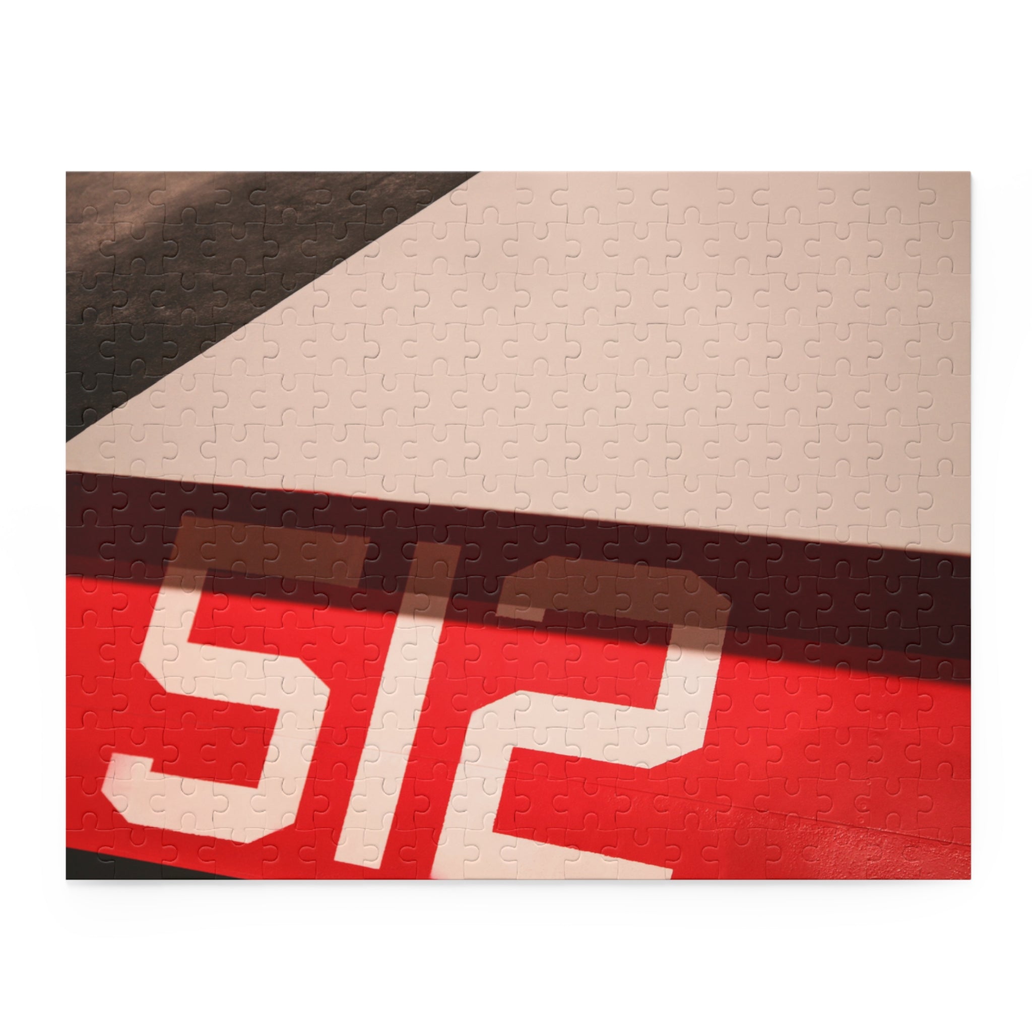 Textile with a patterned design featuring the number '512' on a red, white, and black background.