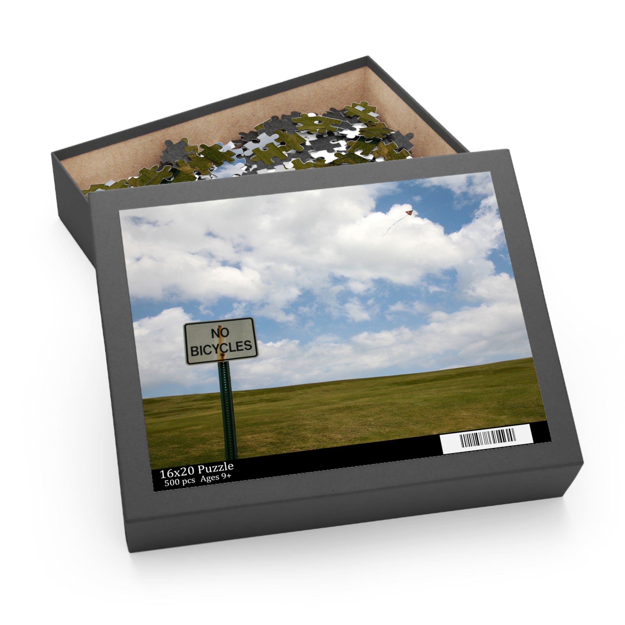 Jigsaw puzzle box with a picture of a 'No Bicycles' sign on a field and sky.