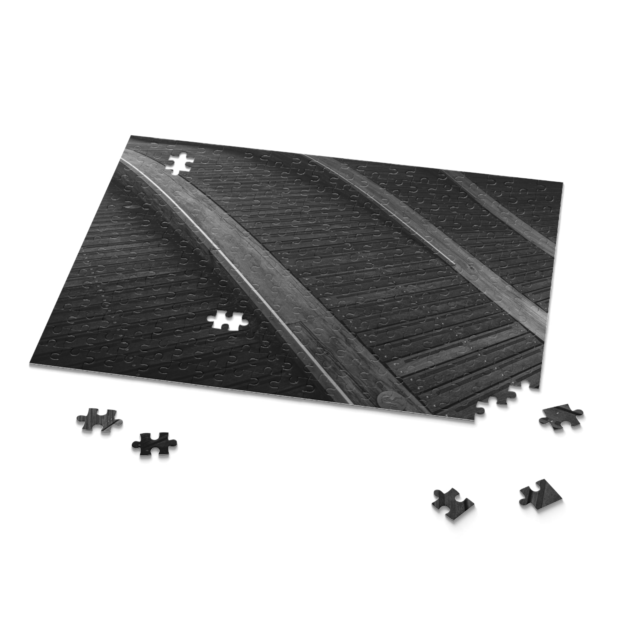 Black and white puzzle with missing pieces on a white background