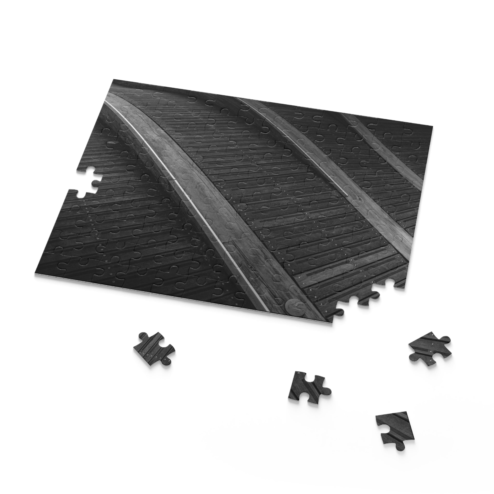 Black interlocking foam puzzle tiles on a white background